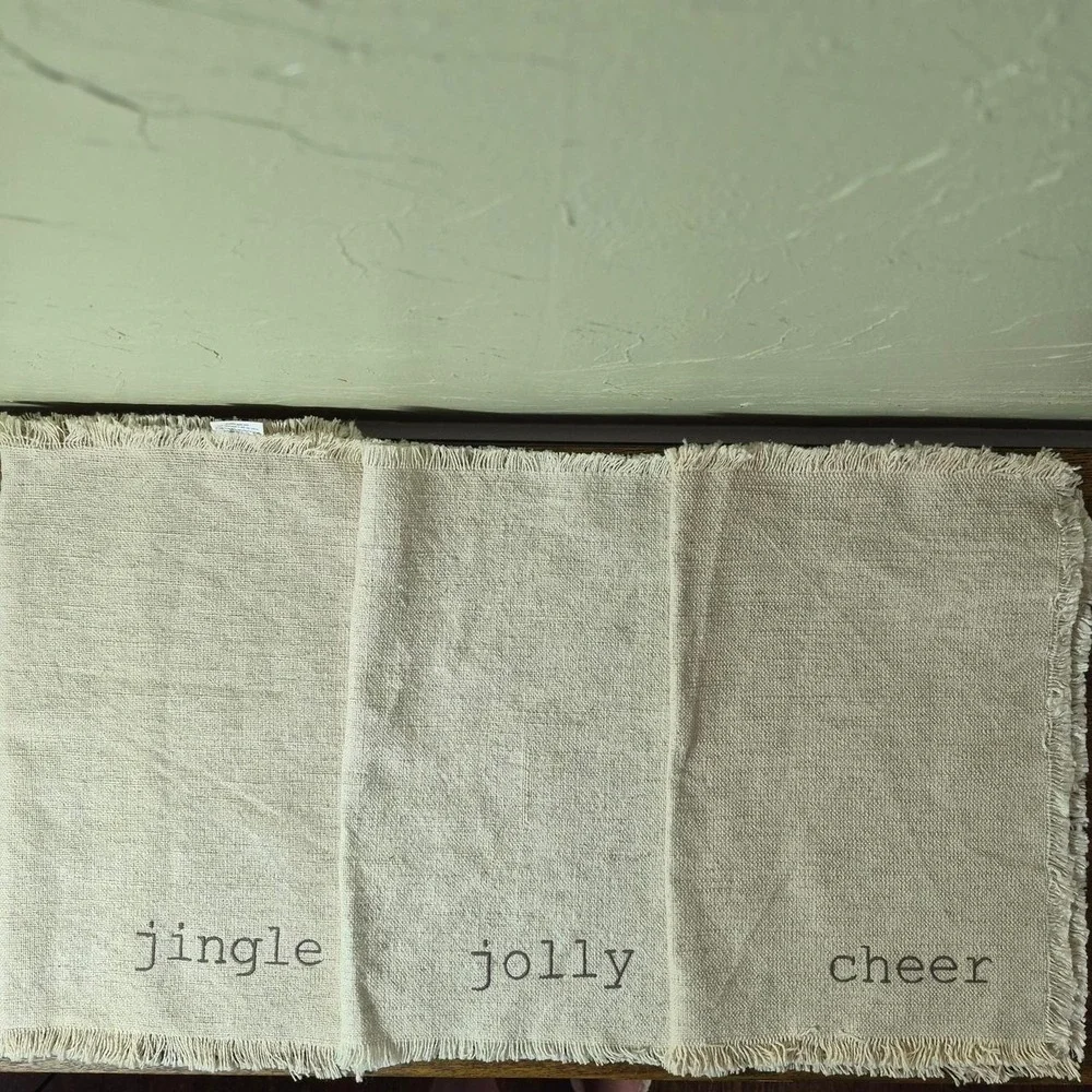 Cream Holiday Placemats (three total) - with the words 'jingle, jolly, & cheer'